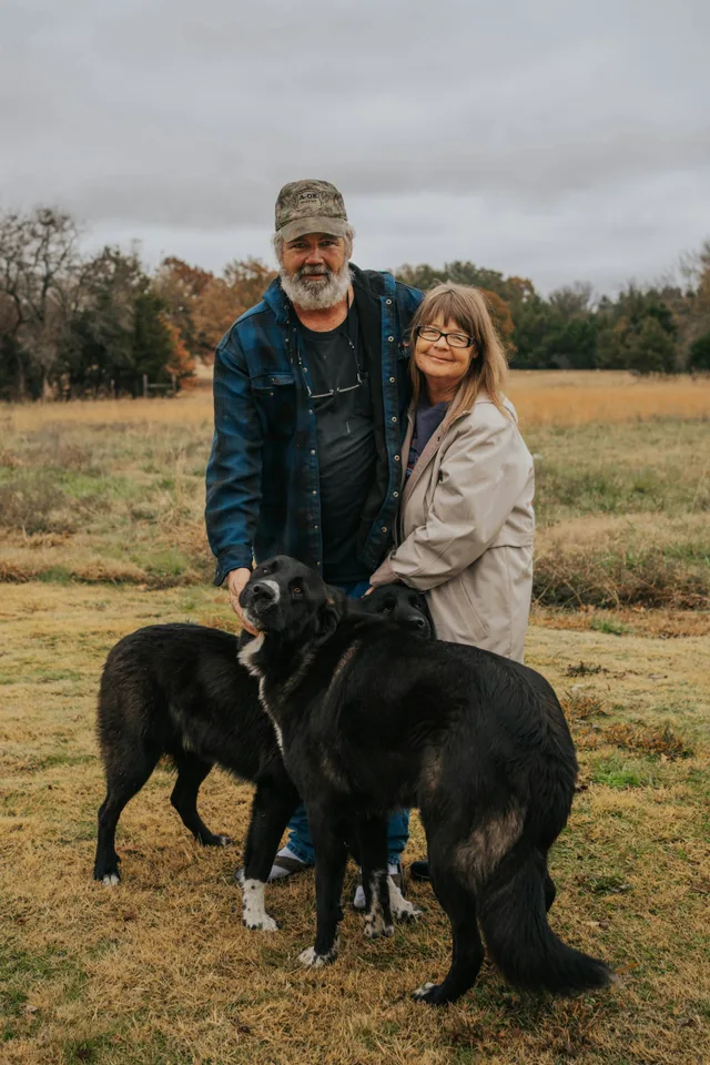 A couple enjoying a day outdoors with their dogs